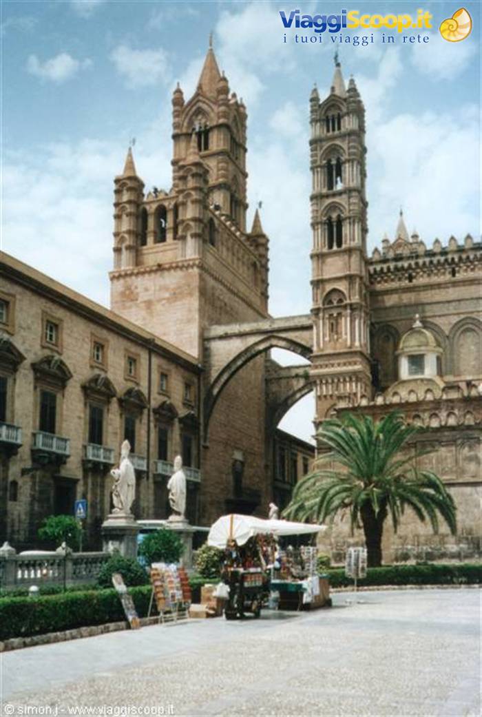 Palermo Cathedral: Gothic stone towers, statue and palm tree by a market stall