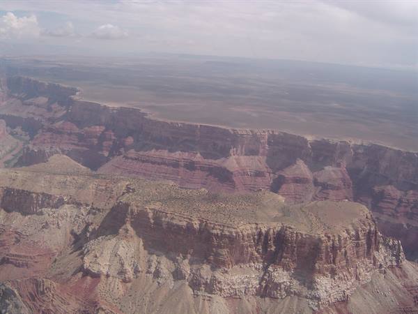 Red rock cliffs of the Grand Canyon under a cloudy sky