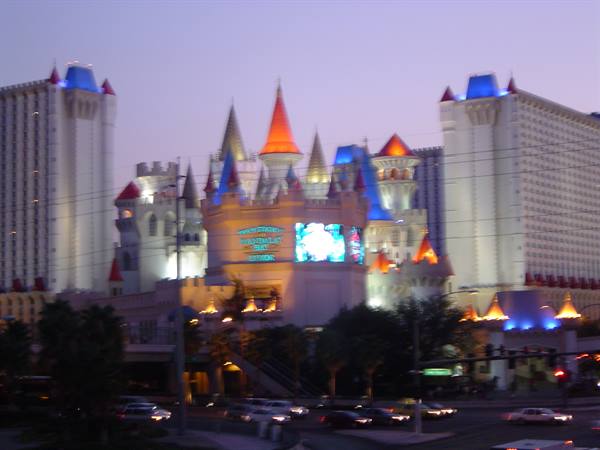 Excalibur castle hotel in Las Vegas lit at night, traffic below