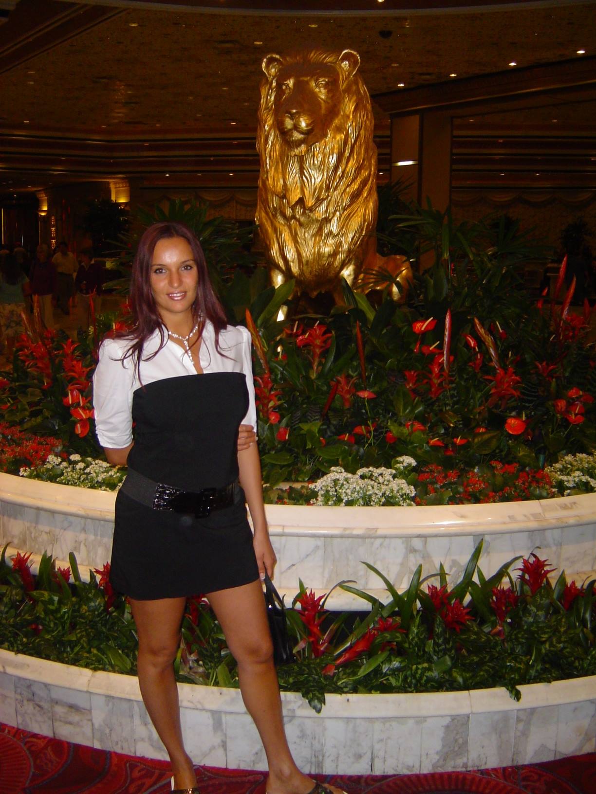 Woman in black dress posing before the golden lion statue at MGM Grand
