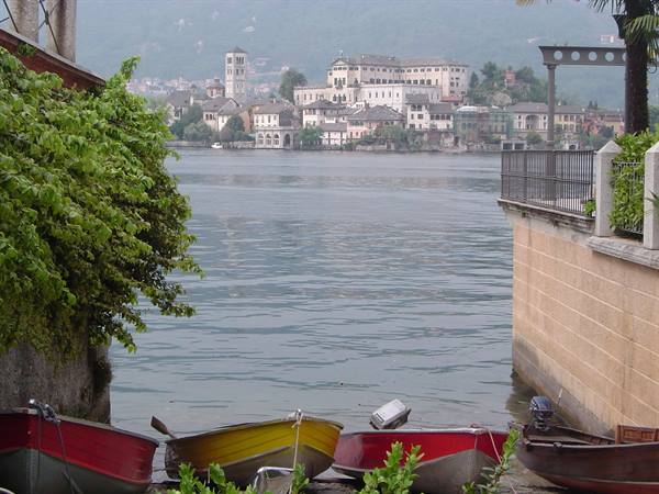 Colorful rowboats moored on the lake facing Isola San Giulio