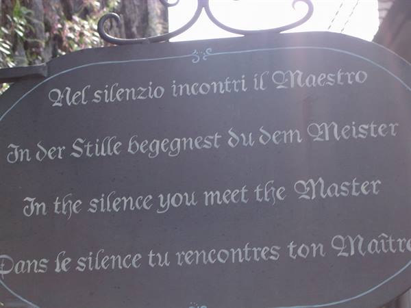 Metal sign with inscription in four languages: in the silence you meet the Master