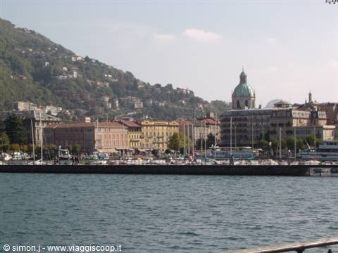 Como lakefront promenade with pier, boats and the cathedral dome