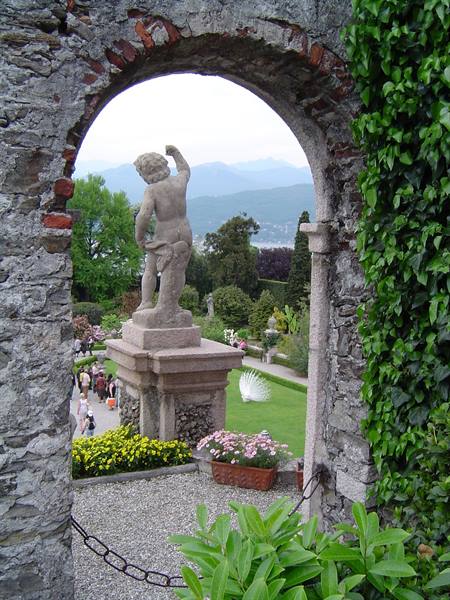 Stone putto statue framed by an arch, gardens of Isola Bella