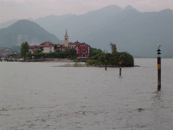 Isola dei Pescatori on Lake Maggiore, houses and bell tower among misty mountains