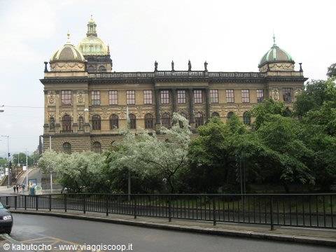 The Rudolfinum in Prague among blooming trees on an overcast day