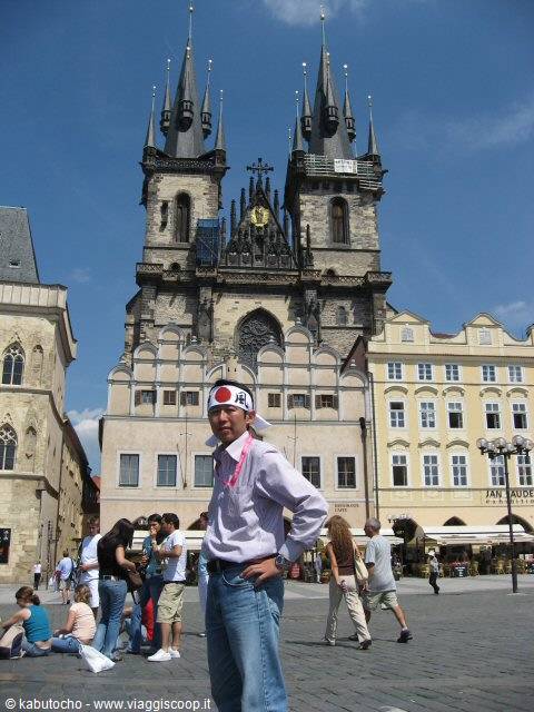 Tourist wearing a bandana in front of Týn Church, Prague
