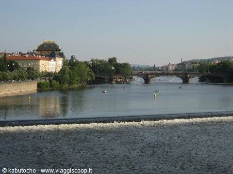 Vltava river with boats and the Legion Bridge in Prague