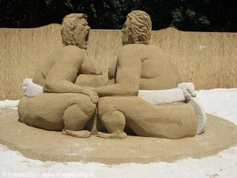 Sand sculpture of two sumo wrestlers sitting face to face