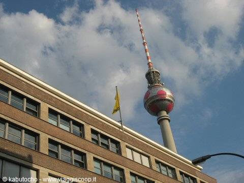 Berlin TV Tower behind the brick facade of a building