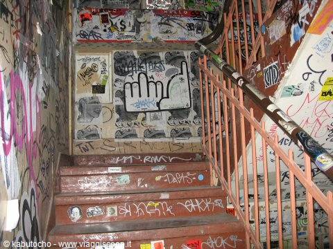 Wooden staircase covered in graffiti and stickers, rusty handrail, Kunsthaus Tacheles