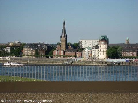 The Rhine river in Düsseldorf with St. Lambertus spire and the Schlossturm tower