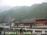 Traditional Chinese rooftops in the mist, stone walls on the hillside
