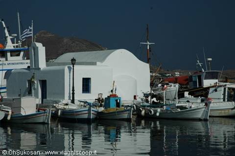 White church and fishing boats in Naoussa harbor, Paros