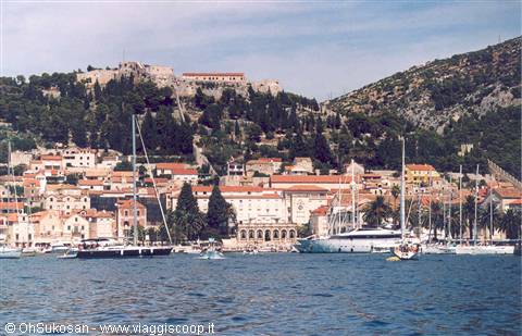 Yachts in Hvar harbor beneath the Spanish fortress on the hills