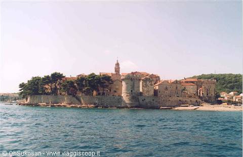 Korčula old town seen from the sea with walls and bell tower