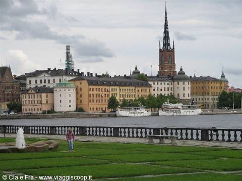 Stockholm: Riddarholmen church towering over pastel buildings along the waterfront