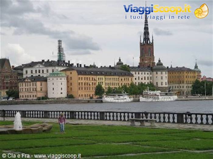 Stockholm: Riddarholmen church towering over pastel buildings along the waterfront