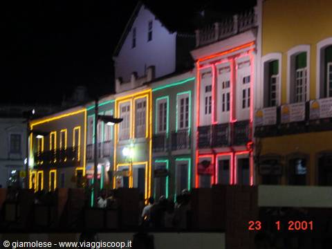 Colonial houses lit by red and green neon lights at night in Salvador