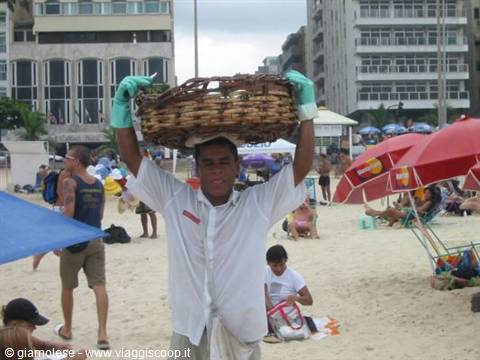 Vendor carrying woven basket on head at Copacabana beach