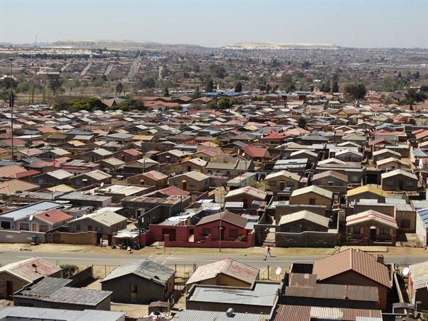 Soweto, man-made hill in the distance.