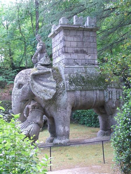 Stone elephant sculpture with tower and warrior, Bomarzo park