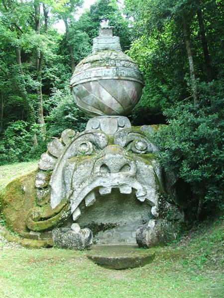 Mossy stone monster head with globe above, Sacro Bosco of Bomarzo