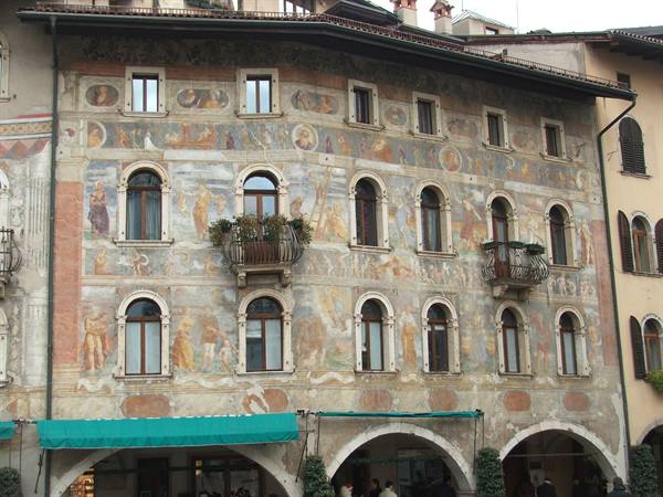 Trento, Piazza del Duomo: painted Renaissance facade of the Cazuffi houses, faded frescoes