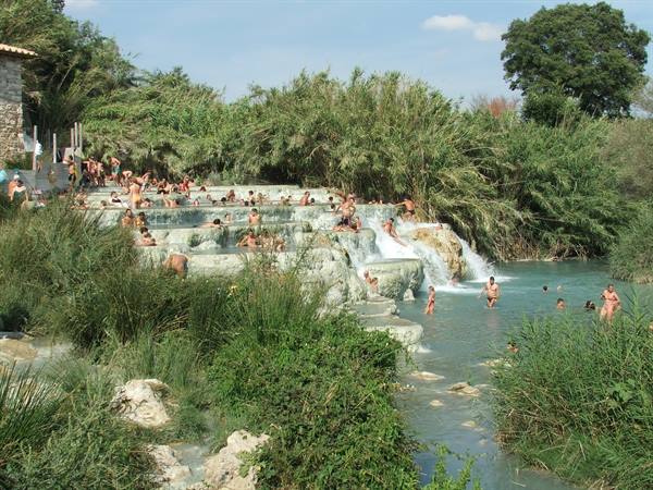 Bathers on the travertine terraces of Saturnia hot springs