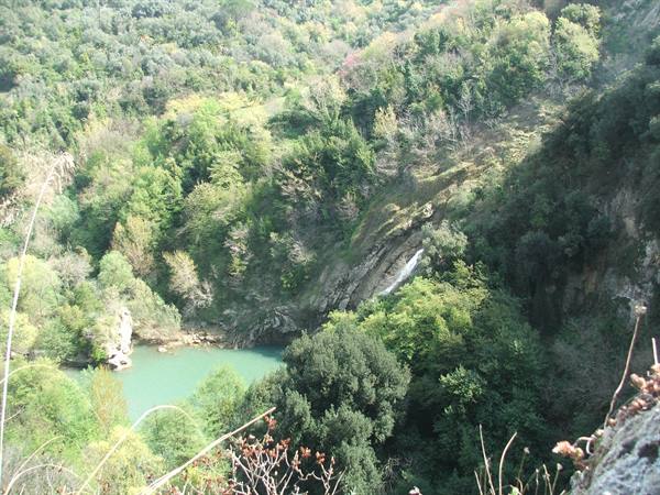 San Domenico lake: waterfall flowing into the green wooded valley