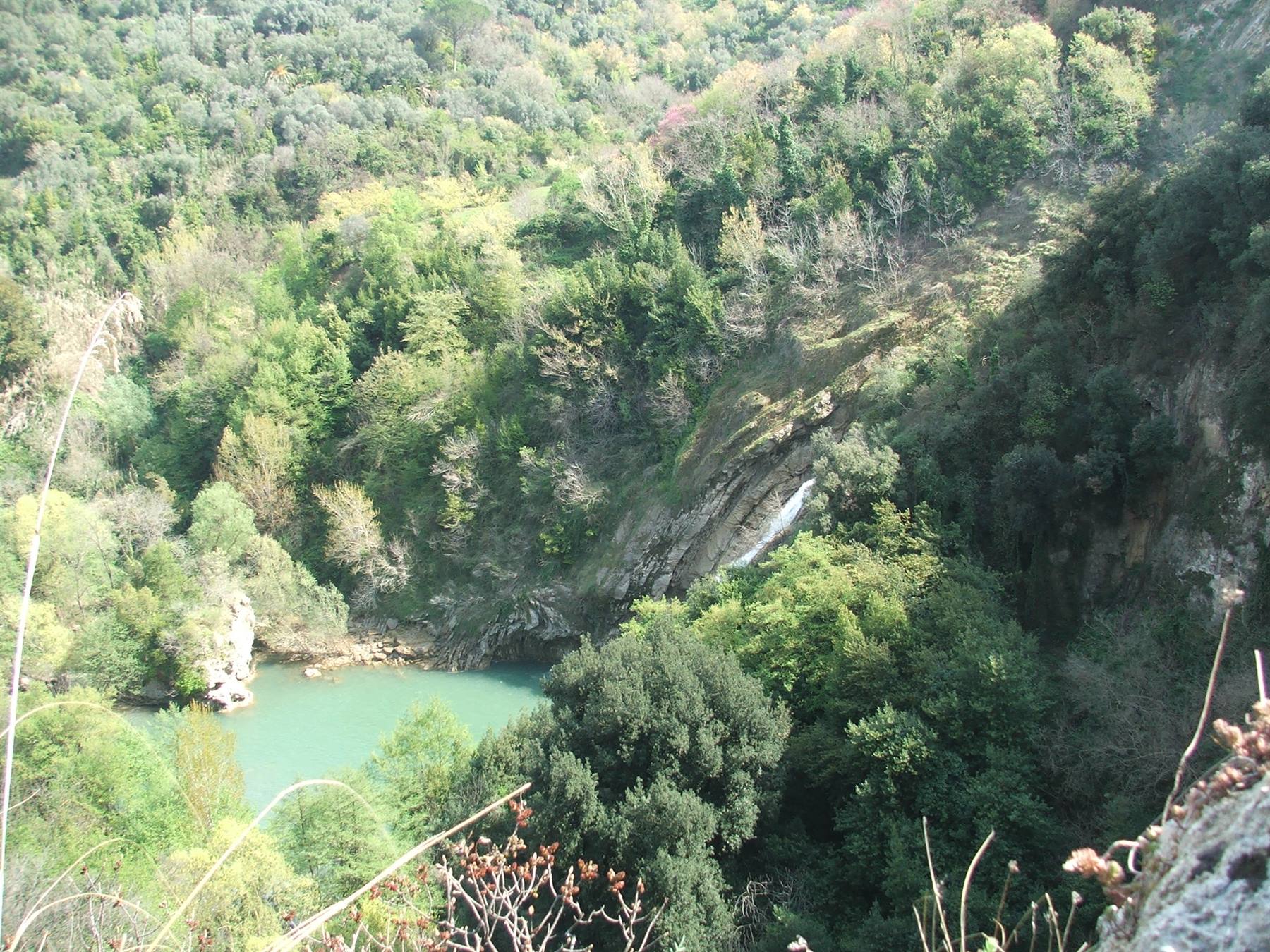 San Domenico lake: waterfall flowing into the green wooded valley