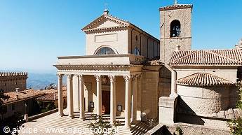 Basilica di San Marino with neoclassical columns and bell tower in sunlight
