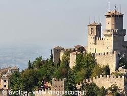 Guaita fortress in San Marino, stone walls and towers above the mist