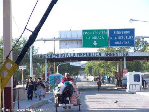 La Quiaca border crossing, loaded cart passing under Argentine welcome signs