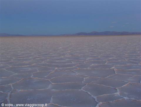 Hexagonal salt crusts on Salar de Uyuni under twilight sky