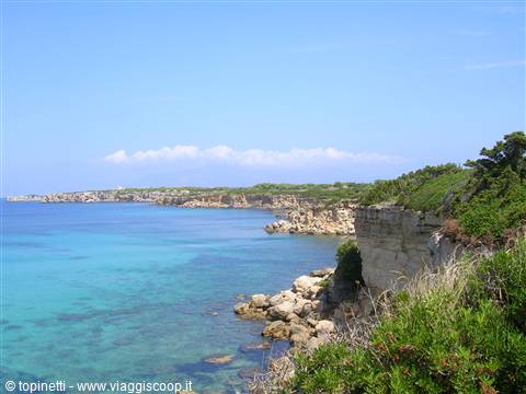 White limestone cliffs and Mediterranean scrub over turquoise sea in Salento
