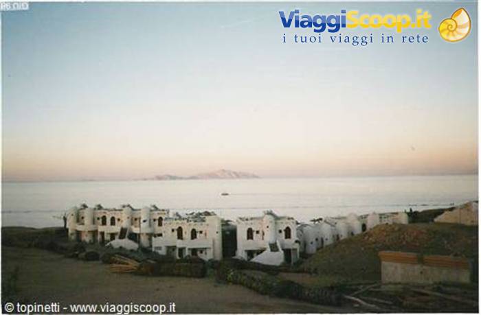 White concrete resort buildings by the shore at dawn, Red Sea
