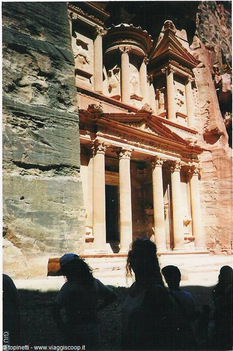 Tourists in backlight before the Treasury of Petra carved in rock