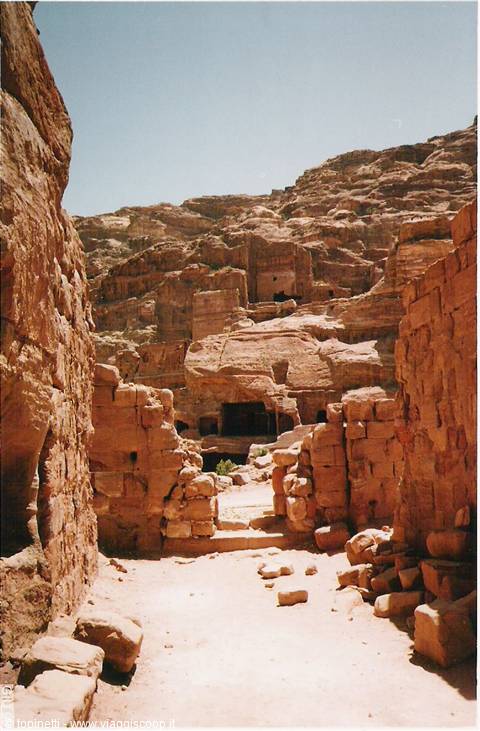 Petra ruins: pink stone walls and rock-cut tombs under bright sunlight