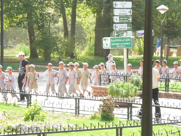 Schoolchildren in grey uniforms walking near Parc de la Prairie, Ifrane