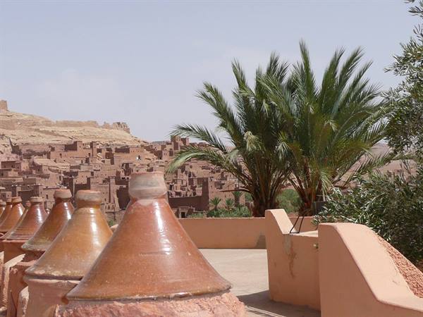 Conical terracotta pot lids on a terrace facing Aït Benhaddou ksar