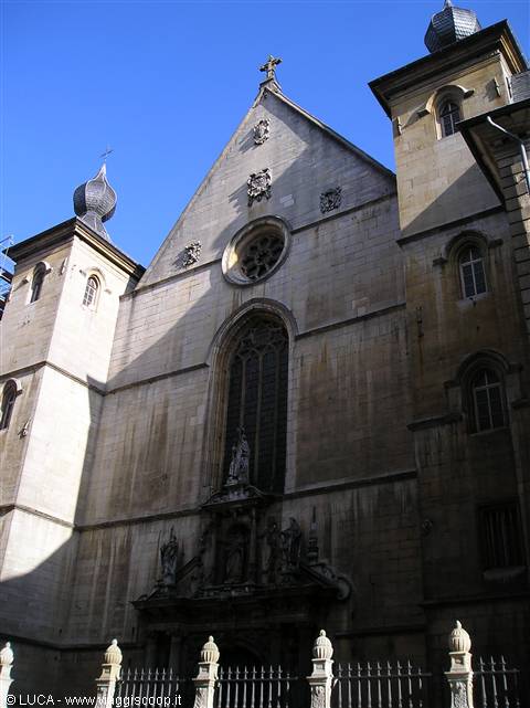 Stone facade of Besançon cathedral with towers and domes