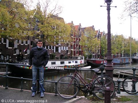 Bicycles leaning on a canal bridge railing, Amsterdam