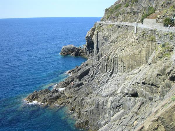 Coastal road carved into cliffs above blue sea, Cinque Terre