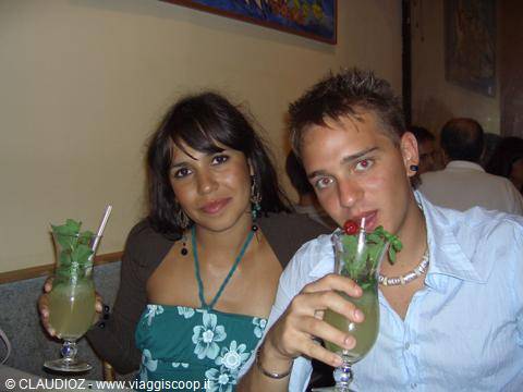 Young couple sipping mint mojitos in an indoor bar
