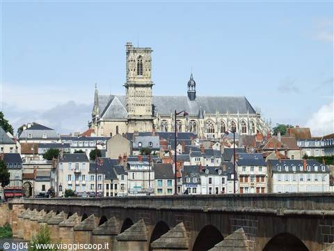 Nevers Cathedral above rooftops, stone bridge over the Loire river