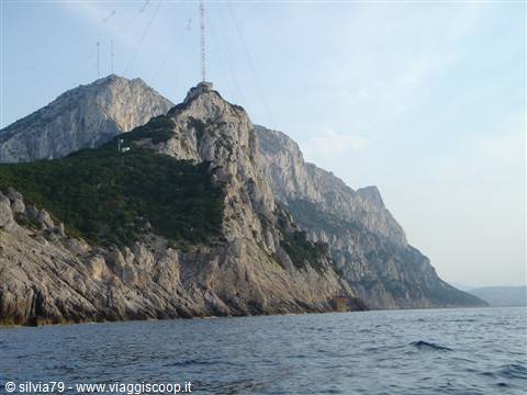 Tavolara mountain: limestone cliffs above the sea, transmission antennas on the peak
