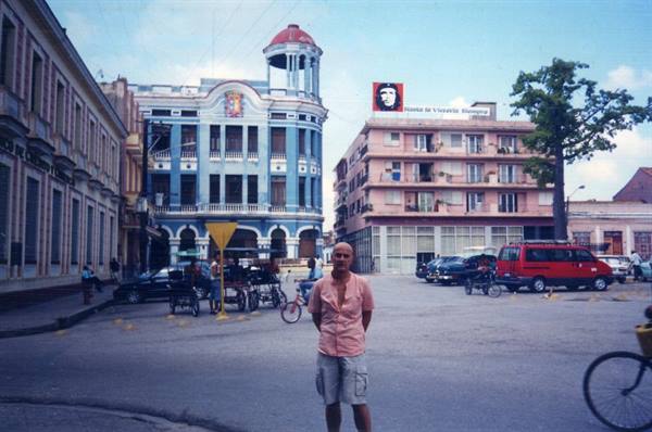 Tourist on a Havana square with Che Guevara billboard
