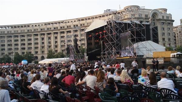 Outdoor concert with crowd on chairs before a stage, Constitution Square, Bucharest