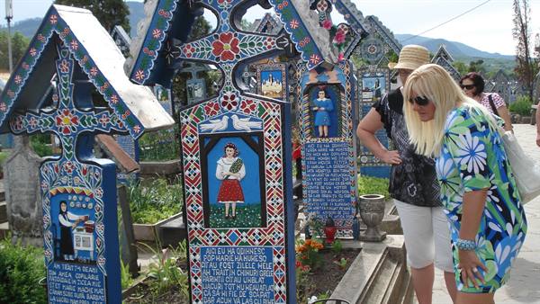 Tourists read the painted blue crosses at Săpânța's Merry Cemetery